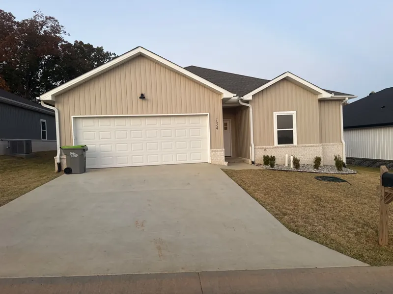 A tan four-bedroom home in Mountain Falls Estates